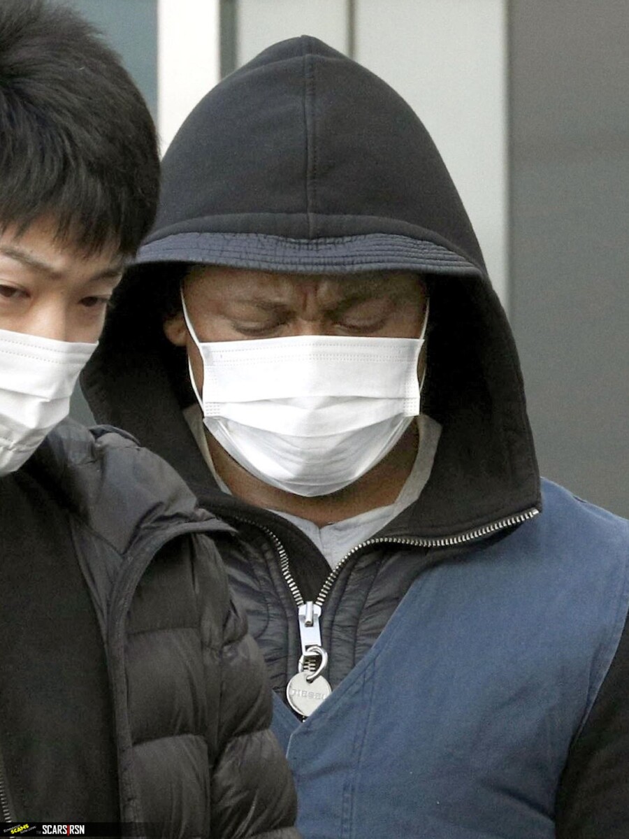 A suspect arrested in a case involving an online romance scam is taken to Fukuoka Prefecture on Tuesday