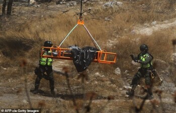 A helicopter extracts bags filled with human remains from the bottom of a ravine in the western Mexico state of Jalisco